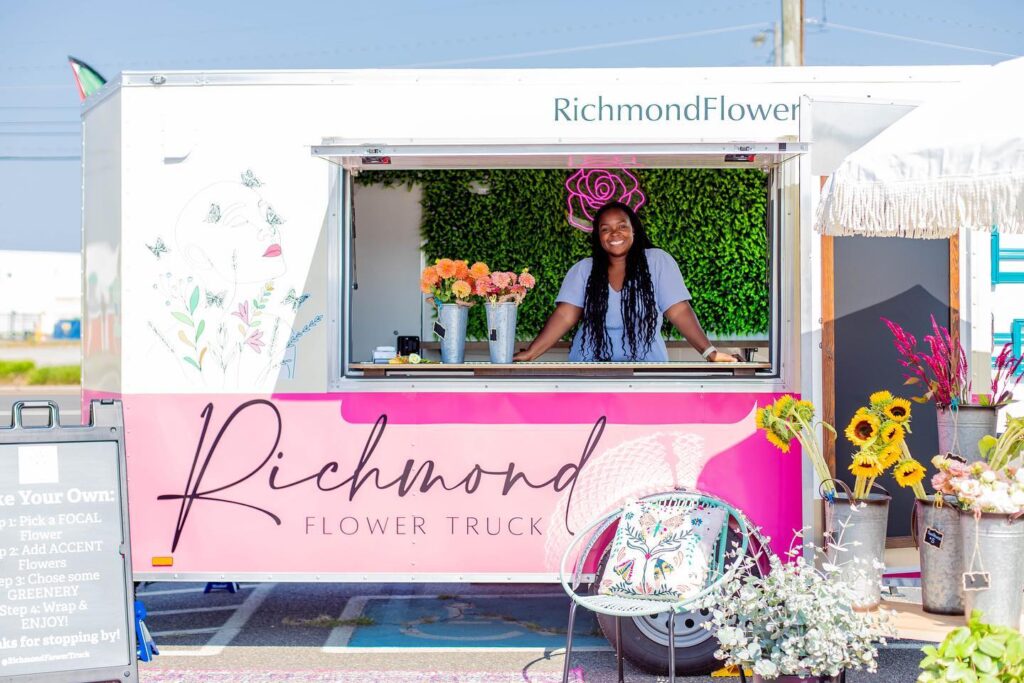 African American woman wearing twists while standing in Richmond Flower Truck trailer.